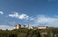 Panorama with Harburg Castle standing on a hill with green trees. The sky is blue with clouds. The castle is built of stones