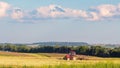 Panorama of harvested agricultural field and tractor plowing land. Endless expanses Royalty Free Stock Photo