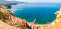 Panorama of high cliffs, Tyrrhenian sea bay with pure azure water, floating boats and ships, pebble beaches, rocky surroundings of