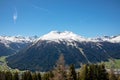 Panorama of high partly snowy mountains at blue sky