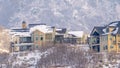 Panorama Hilly residential terrain with charming homes and snowy natural beauty