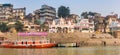 Panorama of historic buildings and boats at the Scindia Ghat in Varanasi