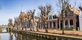 Panorama of historic town hall and old houses at the canal in Balk