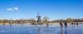 Panorama of the historic windmill at the frozen lake in Groningen