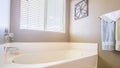 Panorama Home bathroom interior with bathtub in front of the window with blinds