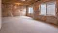 Panorama Home interior under construction with windows installed on plastic covered wall Royalty Free Stock Photo