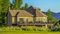 Panorama Home trees and mountain on a scenic landscape under blue sky and puffy clouds