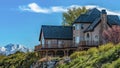 Panorama House with balcony overlooking snow capped mountain and blue sky on a sunny day