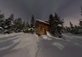 Panorama house chalet during a snowfall in the trees winter forest at night in the moonlight Royalty Free Stock Photo