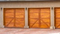 Panorama House exterior with gray and white roof and stylish wooden garage doors