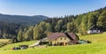 Panorama of a house in the landscape of the Sumava mountains national park