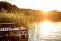 Panorama on huge lake or river near wooden pier in evening with beautiful awesome sunset