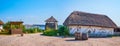 Panorama of Zaporizhian Sich scansen with adobe houses with thathed roofs and wooden defensive tower, Zaporizhzhia, Ukraine Royalty Free Stock Photo