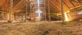 Panorama interior of old farm barn with straw