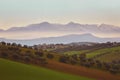 Panorama of the Italian countryside with misty and snowy mountains Royalty Free Stock Photo