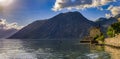 Old stone house in Kotor Bay with mountains and crystal clear water in the Balkans, Montenegro on the on Adriatic Sea Royalty Free Stock Photo