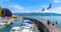 Panorama of Lake Constance or Bodensee, people walk next to yachts in harbor of Lindau, Germany