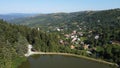 Panorama with lake, hills, forest and village. Rosia Montana Village.