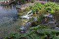 Panorama of lake Kleptuza toward karst spring and waterfall Royalty Free Stock Photo