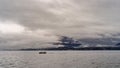 panorama of lake Maggiore on a rainy day with heavy low clouds covering part of the coast Royalty Free Stock Photo