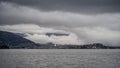 panorama of lake Maggiore on a rainy day with heavy low clouds covering part of the coast Royalty Free Stock Photo