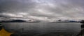 panorama of lake Maggiore on a rainy day with heavy low clouds covering part of the coast Royalty Free Stock Photo