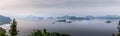 Panorama of Lake Mutanda at morning with view on the volcanoes mount Muhavuru and mount Gahinga in East Africa, along the border o