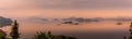 Panorama of Lake Mutanda at morning with view on the volcanoes mount Muhavuru and mount Gahinga in East Africa, along the border o