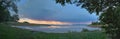 Panorama of a lake near Berlin in the evening with rainy clouds traversing in the background Royalty Free Stock Photo