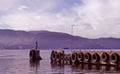 Panorama of the lake with the pier which is covered with tires