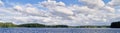 Panorama landscape with dramatic cumulus clouds in the bright summer day scene in Finland