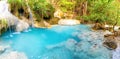 Panorama landscape of lake with cascades of waterfall in tropical forest in Erawan, Thailand Royalty Free Stock Photo