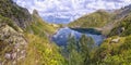 Panorama landscape with a lake in the mountains, huge rocks and
