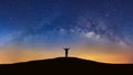 Panorama landscape with milky way, Night sky with stars and silhouette of a standing sporty man with raised up arms on high mount Royalty Free Stock Photo