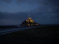 Panorama landscape night view of Mont Saint Michel famous remote isolated island rock castle town in Normandy France Royalty Free Stock Photo