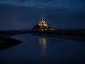 Panorama landscape night view of Mont Saint Michel famous remote isolated island rock castle town in Normandy France Royalty Free Stock Photo