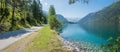 Panorama landscape pictorial turquoise lake Achensee in summer, lakeside bike way Royalty Free Stock Photo