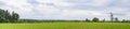 Panorama landscape with a red barn on a green field Royalty Free Stock Photo