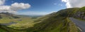 Panorama landscape with the steep and winding mountain road leading to the top of Connor Pass on the Dingle Peninsula