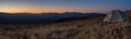 Panorama of landscape with a tourist tent. Mountain peaks Mountain range. Tourism and hiking. Panorama of sunset in the mountains