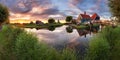 Panorama landscape windmills on water canal in village. Colorful