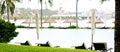 Panorama large ocean view swimming pool with life guard, lounge chairs, beach umbrella, coconut palm trees and waterfront theme Royalty Free Stock Photo