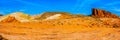 Panorama of a large red sandstone formation among red, white and orange banded rocks on the Fire Wave Trail in the Valley of Fire Royalty Free Stock Photo