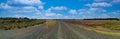 Panorama of levee gravel road on a cloudy day