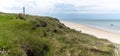 Panorama of the lighthouse and grassy sand dunes above the white sand beach at Hirtshals in northern Denmark