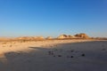 Panorama of the limestone rocks on the horizon in the Dhofar Valley, with sunset light and shadows on the ground. Royalty Free Stock Photo