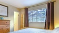 Panorama Lit bedroom of luxury California home with golden light coming from the lamps Royalty Free Stock Photo