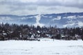 Panorama at the little tourist village in the winter, in the background forest, mountain and ski slope with ski lifts Royalty Free Stock Photo