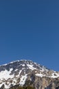 Panorama with lots of snow on Lukmanier in Ticino, on the Swiss Alps. Beautiful closeup of the mountain and blue sky