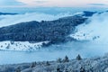 Panorama of the low mountain landscape Rhoen in Germany at dusk, frosty snowy mystic winter nature